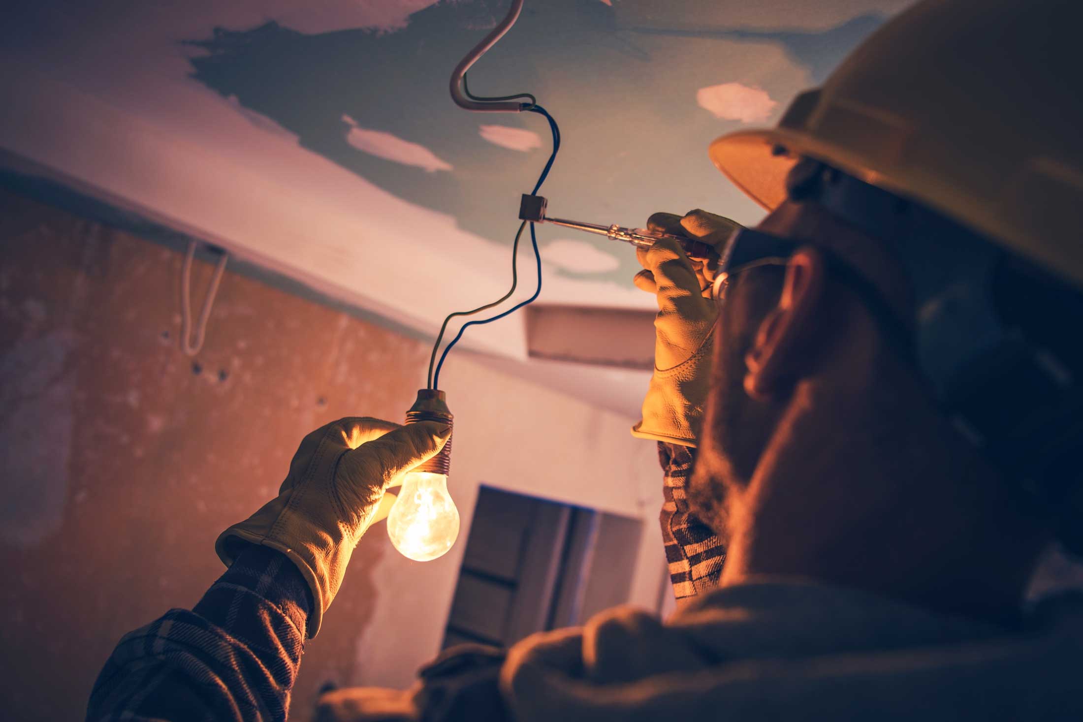 électricien installant une ampoule